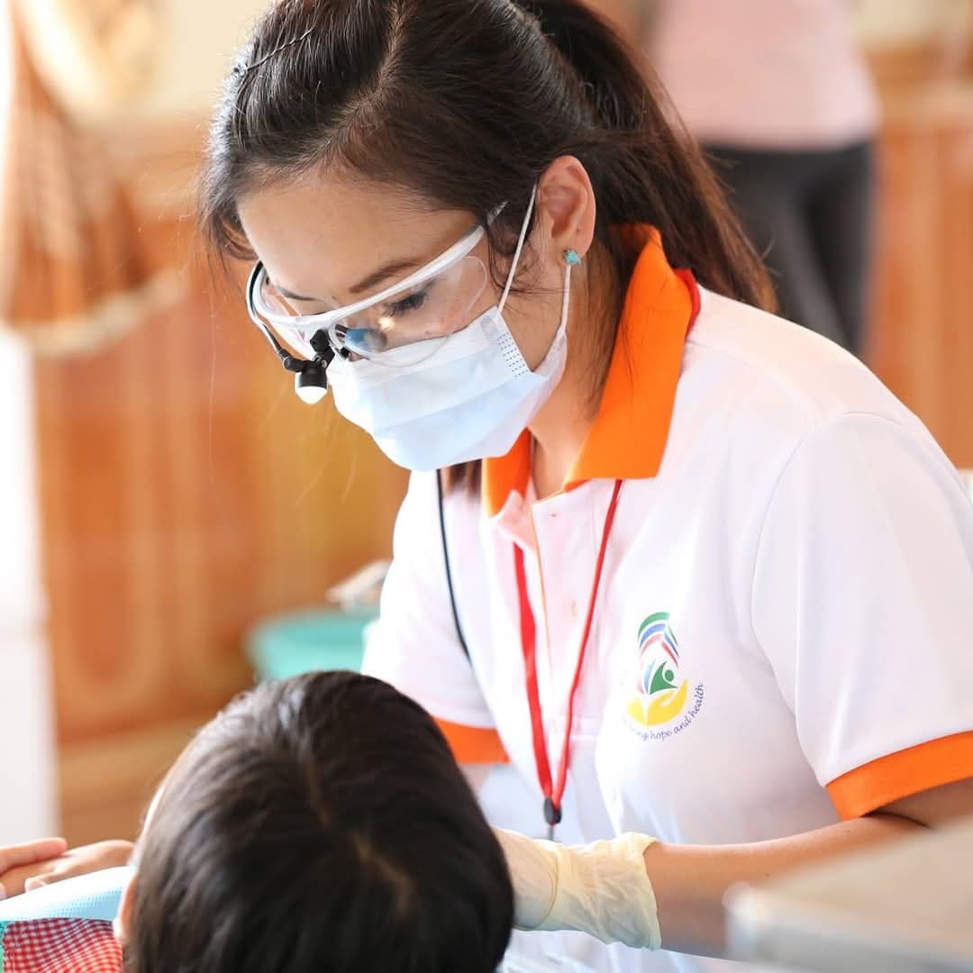 Dr Thao Truong performing oral surgery with clinical staff assisting.